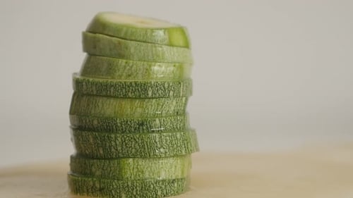 Pepo cylindrica heap close-up 4K 2160p 30fps UltraHD tilting footage - Fresh pieces of zucchini on