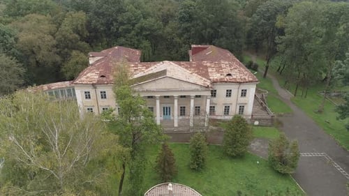Aerial of an abandoned building near a forest