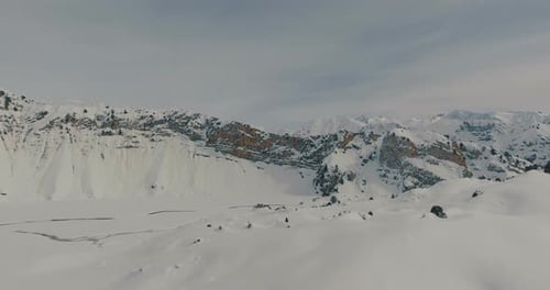 Aerial flying over snow mountains and winter landscape