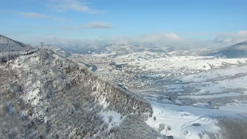 Top down aerial drone view of the snow-covered woods after a snowfall.