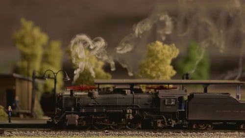 Model Steam Train Moving Through Station Close Up