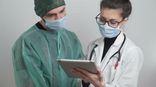 Doctors Using Tablet Computer in Hospital Setting