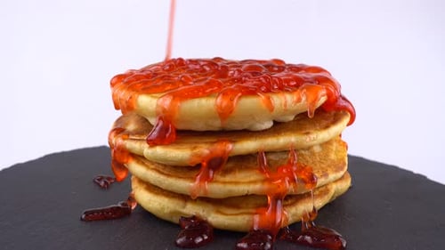 Stack of Pancakes with Red Strawberry Jam Topping
