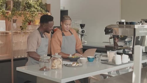 Cafe Workers Collaborating in Urban Cafe Setting