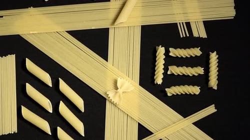 Variety of Uncooked Pasta Types on Black Surface