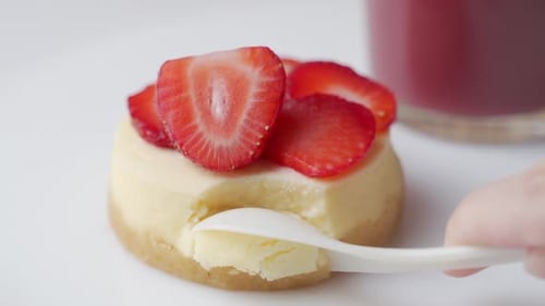 Close up Eating Strawberry Cheesecake with Spoon