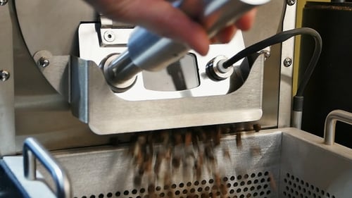 Releasing Roasted Coffee Beans into Metal Basket