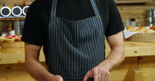 Waiter using digital tablet in cafe