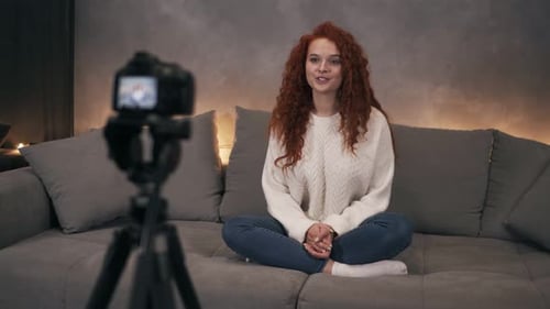 Young Woman Vlogging from Home on Couch