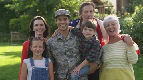 Smiling Family with a Soldier on a Lawn