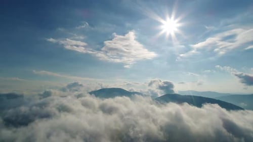 Aerial View Over Mountains With Heavenly Clouds
