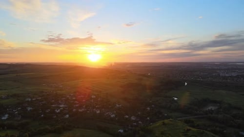 Aerial view of residential houses in suburban rural area at sunset.