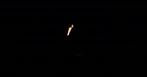 Dramatic Fire Performer Blows Flames in Dark Frame