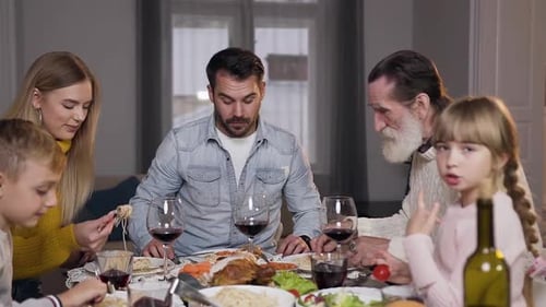 Family Celebrates Birthday with Dinner and a Toast