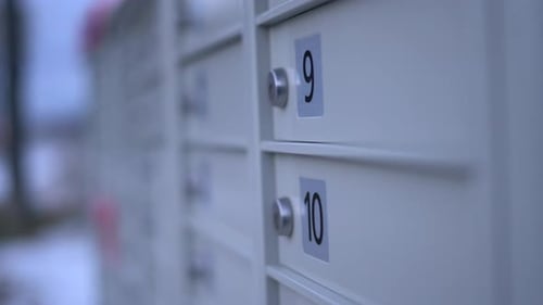 Closeup of Community Mailbox during winter - Canadian Modern Canada Post mail boxes set in the neigh