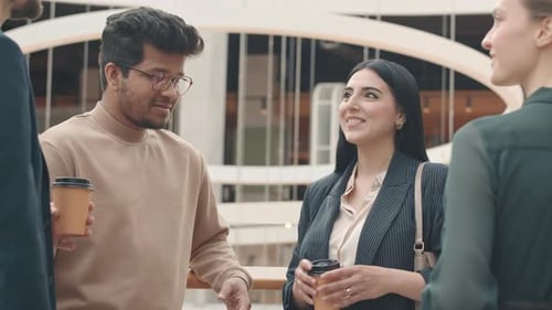 Young Adults Chatting During Coffee Break at Work