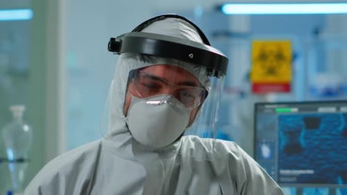 Close Up of Tired Chemist Man Doctor in Coverall Working in Lab