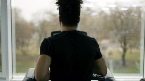 Man Trains in Gym Doing Cardio Workout on Treadmill Back View