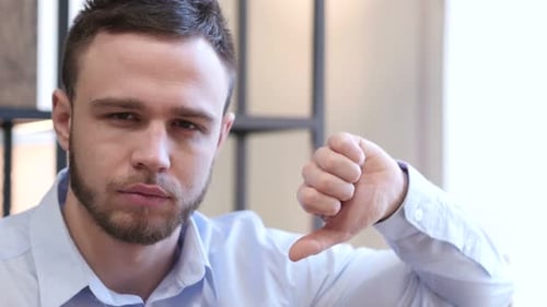 Thumbs Down by Young Man