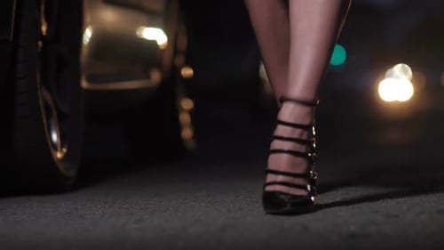 Woman Walking in Strappy Heels at Night