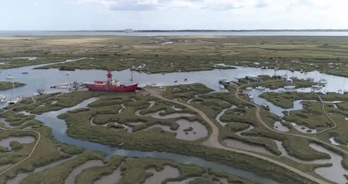 Aerial track above Tollesbury marina looking out over the marsh