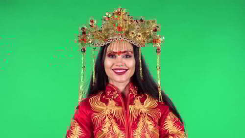 Woman in Traditional Dress Poses Against Green Screen