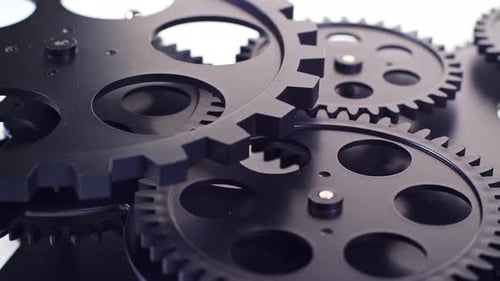 Black Mechanical Gears Turning in Close Up