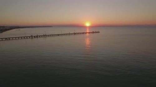 Flying Over Sea and Pier at Sunset