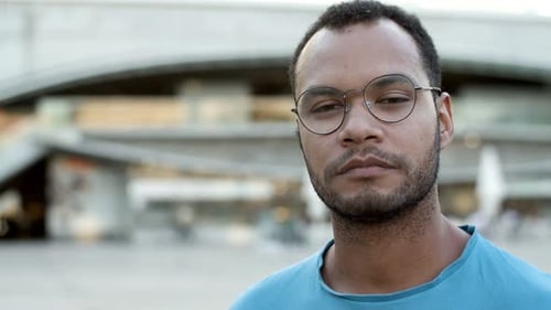 Man with Glasses Opens and Closes Eyes