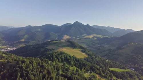 Aerial View of Green Countryside in Alpine Forest Mountains