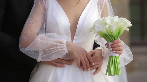 Bride in White Dress Holding Wedding Bouquet