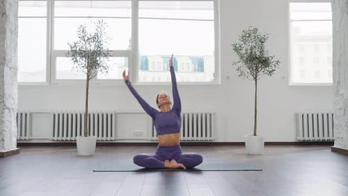 Woman Doing Yoga Indoors in Bright Studio