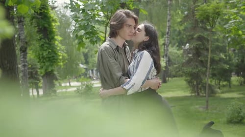 Young Couple Sharing a Romantic Moment in Park