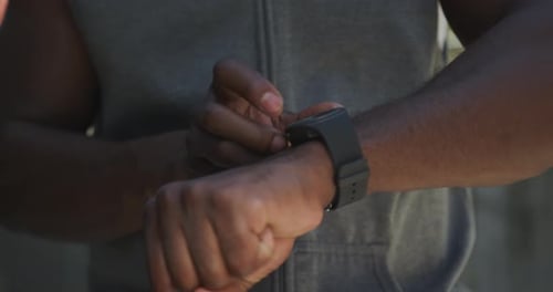 Close Up of Person Tapping Smartwatch Outside