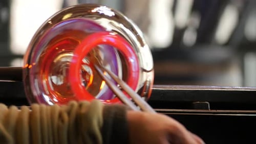 Glass Blower Shaping a Colorful Glass Orb
