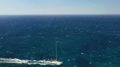 An aerial view of the yacht on the azure sea. Transparent clear water in the Mediterranean Sea.