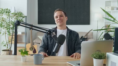 Man Recording a Podcast at His Desk