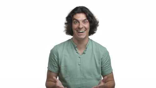 Video of Handsome Hispanic Man in Green Shirt Looking Impressed Clench Hands and Shaking Them with