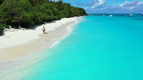 Tourist sunbathes on relaxing tourist beach adventure by blue lagoon and white sandy background of t