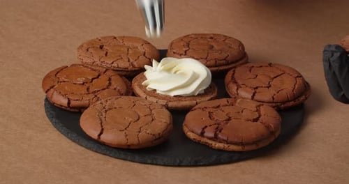Pastry Chef Making Chocolate Cookies with Cream