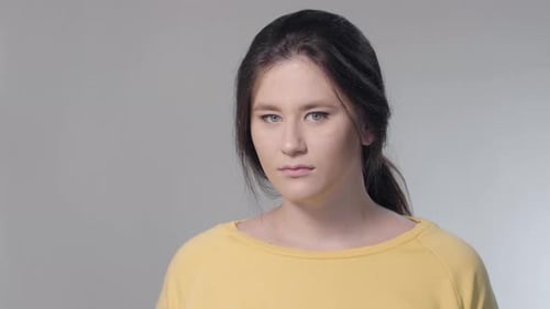 Close-up Face of Displeased Caucasian Woman Turning To Camera and Looking with Disdain Expression