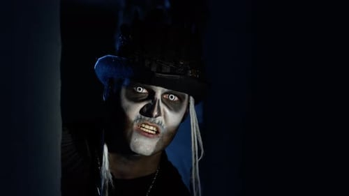 Sinister Man with Halloween Skeleton Makeup Quickly Appears From Dark Corner, Trying To Scare