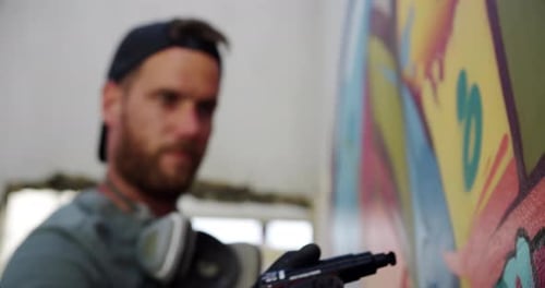 Graffiti Artist Drawing Colorful Mural on Wall
