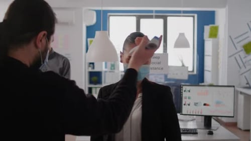 Temperature Check in a Modern Office Setting