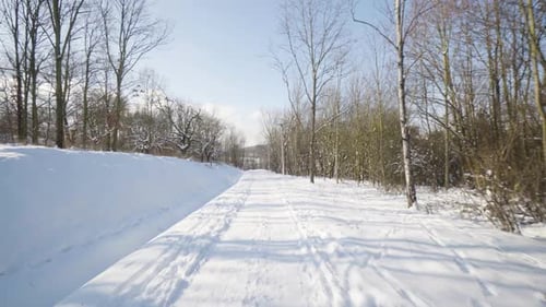 POV a Man Walks Down a Path in a Snowcovered Park in Winter