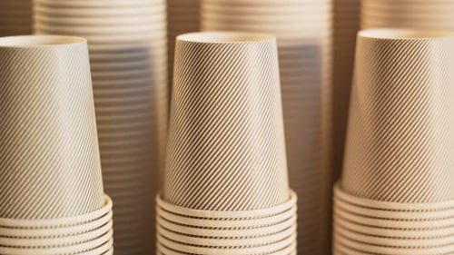 Footage of assorted disposable cups. Stacks of cups. Close up. Panning around
