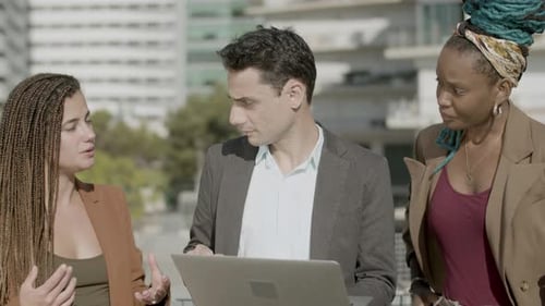 Front View of Focused Coworkers Working Together Outdoor