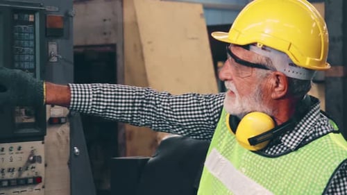 Senior Factory Worker Teach How to Use Machine Equipment in the Factory Workshop