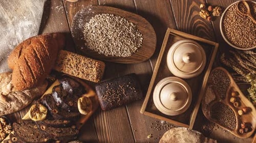 Assortment of Breads and Grains on Wooden Surface