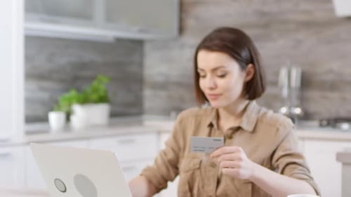 Woman Shopping Online with Laptop and Credit Card